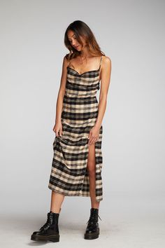 If you don't own Flannel in your winter wardrobe, have you ever gone shopping? Our Flannel Midi Slip Dress is equal parts seasonal and stylish, with a Side-Slit and some cleavage. Pair with black combat boots for an effortlessly edgy aesthetic. Black and beige are a combo of the season, so prepare for plenty of wear! Flannel Midi Slip Dress Fabric Content: 100% Cotton Model is 5'9" and wearing size small Imported Style: CW9354-LP Grunge Midi Dress, Plaid Dress Outfit Summer, Midi Slip Dress Outfit, Midi Dress With Boots, 90s Plaid Dress, Plaid Dress Outfit, 90s Midi Dress, Plaid Slip Dress, Slip Dress Outfit