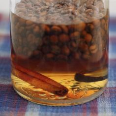 a glass jar filled with liquid and cinnamon sticks