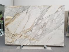 a large marble slab sitting on top of a metal stand in front of a mirror