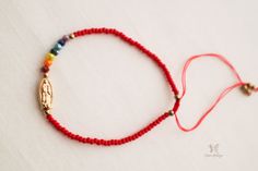 Our Virgin of Guadalupe bracelet is to be proud of. It's a statement piece that looks great alone or with other bracelets. Embody Mexican culture with this one of a kind Guadalupe bracelet that's adorned with dainty red beads and 7 colorful beads symbolizing the 7 chakras which adorn a gold medal image of Our Lady of Guadalupe. This bracelet is perfect for any occasion and will be with you for the rest of your life. Treat yourself or someone you love to the Guadalupe bracelet today! Let this pie Red Beaded Spiritual Bracelet, Spiritual Red Beaded Charm Bracelet, Adjustable Red Spirituality-inspired Bracelet, Red Spiritual Charm Bracelet, Spiritual Our Lady Of Guadalupe Bracelets As Gifts, Guadalupe Bracelet, Smudging Feathers, Crystal Bath, Virgin Of Guadalupe