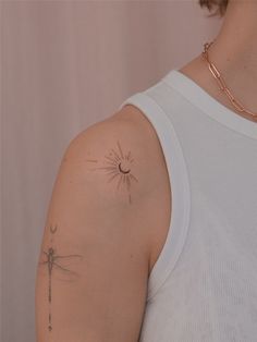 a woman with a tattoo on her arm and a dragonfly in the middle of her arm