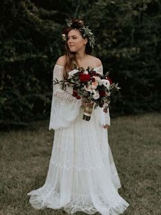 a woman in a white dress holding flowers and wearing a flower crown on her head