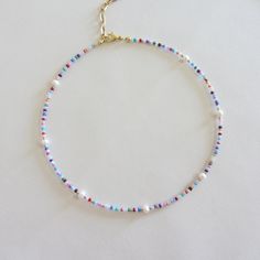 Colorful beaded choker necklace, Freshwater pearl necklace, 18k gold necklace, Rainbow seed bead necklace for women I offer two versions of an iridescent necklace with freshwater pearls, with gold beads, with a clasp and chain extension made of brass with 18k gold plating. Second version of the necklace with silver beads and stainless steel clasp. Measure the length of your neck with a measuring tape or you can use any string, rope or phone cable, and afterward apply the measurements on a regula Pearl Chain Choker With Round Beads, Pearl Choker With Colorful Beads For Gifts, Pearl Choker With Tiny Beads, Pearl Choker With Colorful Round Beads, Colorful Pearl Beaded Choker Necklace, Pearl Choker Necklace With Colorful Beads, Pearl Choker Necklace With Tiny Beads, Dainty Pearl Beaded Necklaces With Tiny Beads, Dainty Colorful Beaded Choker Necklace