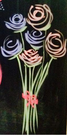 some flowers are on a black background with pink and blue swirls in the center