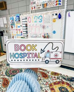 a person holding up a sign that says book hospital