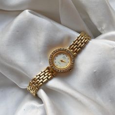 Women's EJ gold toned clasp band style watch. gold circular face with silver numbers and gold hands. Approximately 7.75 inches - rhinestone details around and on the face . TICKING/WORKING - new battery Cleaned, polished, refurbished, and tested to the best of my ability. coastal grandmother, coastal granddaughter, clean girl, vanilla girl, old money, coquette, soft girl, lo fi, maximalist, y2k, sad girl, twee, academia, plazacore, whimsigoth, weird girl, fairycore, kidcore, gorpcore, minimalist, retro, indie, skater, baddie, techwear, cottage core, dark academia, barbiecore, angelcore, balletcore, coastal cowgirl, countrycore, preppy, craftcore, normcore, vacationcore, europecore, italycore, quiet luxury, vintage, avant garde Metal Diamond Watch, Metal Diamond Watch With Metal Dial, Diamond Watch With Metal Dial, Elegant Gold Metal Diamond Watch, Gold Diamond Watch With Round Face, Timeless Gold Jewelry And Watches With Round Shape, Gold Diamond Watch With Metal Round Dial, Formal Metal Diamond Watch With Round Dial, Gold Analog Diamond Watch