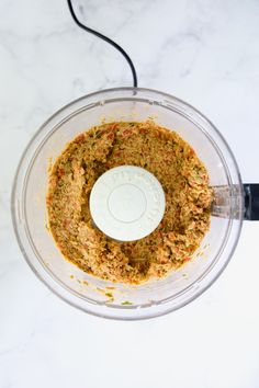 an overhead view of a food processor with ingredients in it