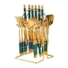 gold and green utensils in a rack on a white background