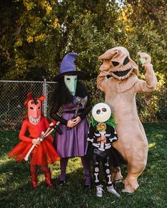 three people in halloween costumes posing for the camera