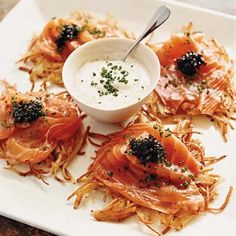 a white plate topped with lots of food next to a bowl of ranch dressing on top of it