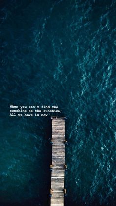 an aerial view of the ocean with a pier in the foreground and a quote written on it