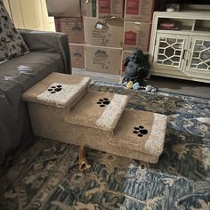 a dog is sitting on the floor in front of a couch with paw prints on it