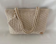 Discover our 2 in 1 patterned crochet bag in beige, a perfect choice for handmade crochet bag enthusiasts!  👜 Designed to complement any style, this bag features an elegant pattern and comfortable shoulder strap for easy daily use. It was made using slim supra thread that will give you a stunning look in the summer nights. 📏Measuring 8.27 inches height, 11.42 inches width, and with a lined interior, it's the perfect size for carrying your essentials. The 7.87 inches handle drop allows for comfortable wear over the shoulder. It is made by weaving onto a gold-colored chain.  👛The purse-shaped accessory on the handle of the bag adds a stylish look.     *This is not a purse.* 🎁💝 It also makes a great gift option for women who appreciate unique and stylish accessories. Our bag is carefully Elegant Shoulder Bag With Long Handle For Daily Use, Elegant Long Handle Bags For Daily Use, Elegant Natural Shoulder Bag With Braided Handles, Classic Beige Bag For Gift, Classic Beige Bags For Gifts, Elegant Natural Shoulder Bag For Travel, Elegant Square Beach Bag, Elegant Crochet Tote Bag For Summer, Elegant Crochet Travel Bag For Summer