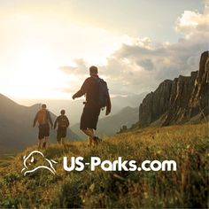 three people hiking up a hill with the sun setting in the background and us parks logo on it