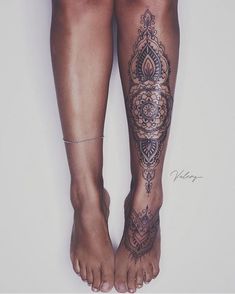 a woman's legs with tattoos on them