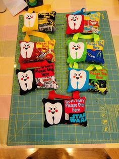 several tooth shaped candy bags sitting on top of a cutting board