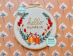 an embroidered hoop with the words hello pumpkin on it