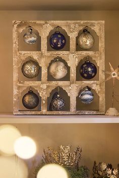 an assortment of christmas ornaments are displayed on shelves