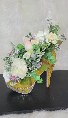 a shoe with flowers in it sitting on a table