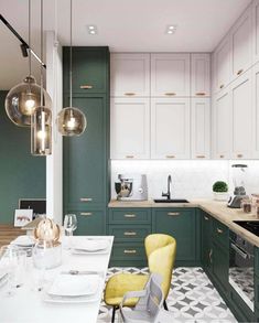 a kitchen with green cabinets and white countertops is pictured in this image, there are two yellow chairs at the center of the table