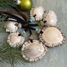 several seashells with beaded decorations on them next to a christmas ornament