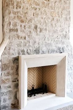 a fireplace in a room with stone walls