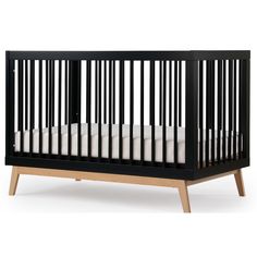 a black crib with white sheets on the bottom and wood trimmings, in front of a white background