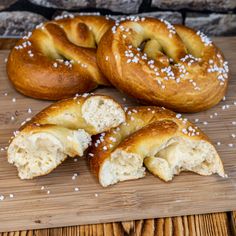 several bagels are on a cutting board with white sprinkles around them