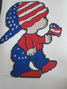 a cross stitch pattern of a boy with an american flag hat