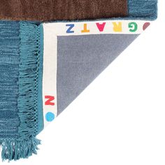 a blue, brown and white rug with letters on the bottom corner that spell out zlvg