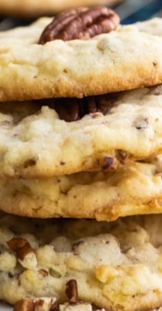 three cookies stacked on top of each other with pecans in the middle and walnuts at the top