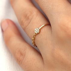 a woman's hand with a diamond ring on it