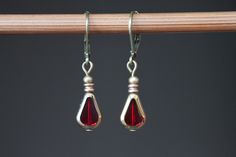 Small Red Earrings, Czech Glass Earrings, Red Dangle Earrings, Drop Earrings, Teardrop Earrings, Gift For Women, Gift for Her Lovely, tiny dangle earrings made with red teardrop czech glass beads and gold tone plated spacer beads. They hang from antique brass lever backs ( lead and nickel free). Color : Red teardrop and gold Czech glass beads. Finish : Antique gold plated spacer beads, antique brass findings Length : 1 1/8 inches including the antique brass lever back Ear wires : Antique brass l Nickel Free Red Drop Earrings, Nickel Free Red Teardrop Earrings, Nickel-free Red Teardrop Earrings, Red Nickel-free Teardrop Earrings, Red Nickel-free Teardrop Dangle Earrings, Red Earrings Dangle, Earrings Teardrop, Earrings Red, Red Earrings