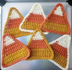 four crocheted pieces are arranged in the shape of trianglees on top of each other