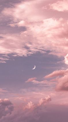 the moon is in the pink sky with clouds