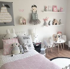 a child's bedroom decorated in pink and white