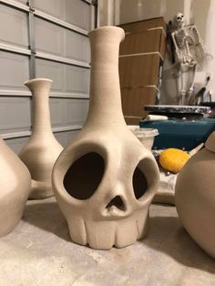 three clay vases sitting on top of a table