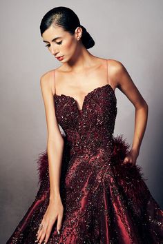 a woman in a red dress posing for the camera