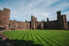 an old castle with grass in the foreground