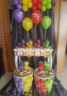 a table with balloons and desserts on it