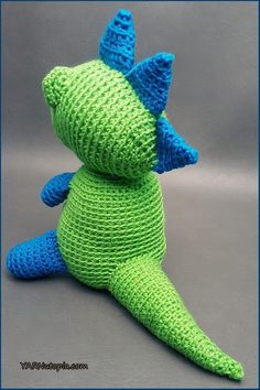 a crocheted green and blue stuffed animal