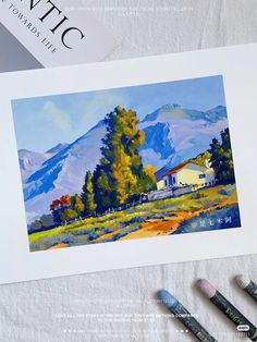 a painting of a house in the mountains next to some paint brushes and watercolor pencils