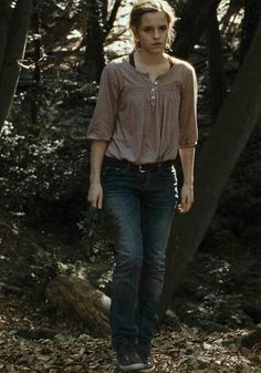 a young woman walking through the woods