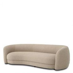 the curved sofa is made out of fabric and has a rounded back, with an extended seat