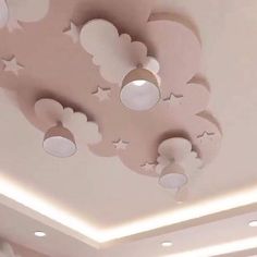 the ceiling is decorated with clouds, stars and moon shaped lights in shades of pink