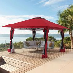 a red and white gazebo sitting on top of a wooden deck