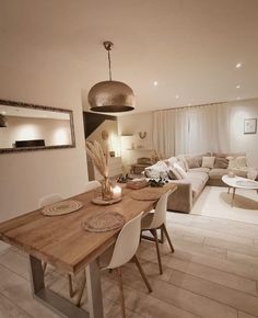 a living room and dining area with white furniture