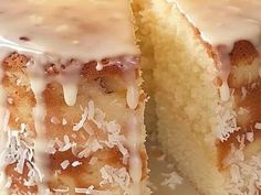 a close up of a cake with icing and coconut