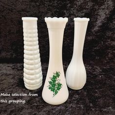 three white vases sitting next to each other on a black surface with the words make selection from this grouping