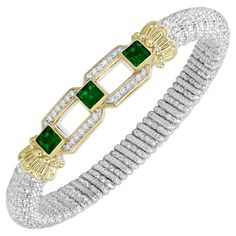 All of your friend's will be in a flutter when they see this beautiful bracelet gracing your wrist. This 8mm bracelet by Alwand Vahan is sterling silver, 14k yellow gold, and has .21 carats of diamonds and three princess cut green chrome diopside gemstones that will leave you speechless. Designer: Alwand Vahan Metal: 14k Yellow Gold & Sterling Silver Diamond Total Weight: 0.21 carats Band Width: 8 mm Wrist Size: M Natural Genuine Diamonds (Color: G-H, Clarity: VS2-SI1) Fits a wrist measuring from 6.25" to 6.75" Vahan Jewelry, Green Chrome, Diamond Bracelets, Sterling Silver Bands, Silver Diamonds, Princess Cut, Beautiful Bracelet, Sterling Silver Bracelets, Gemstone Jewelry